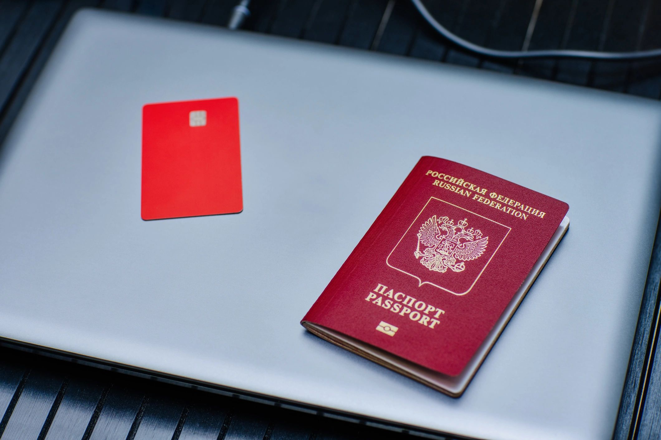Passport, credit card, and laptop reflecting global business immigration